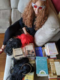 Maude with wigs and books