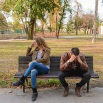 Man and woman arguing on bench