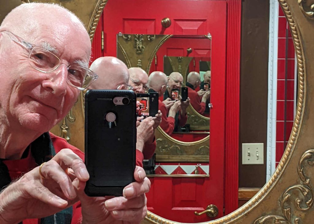 Man with multiple reflections in mirror
